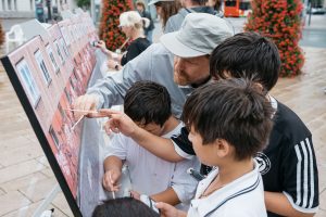 Children and adults repaint a photographic surface together as part of the “buffing” discipline at the Hammer Caretaker Championships.